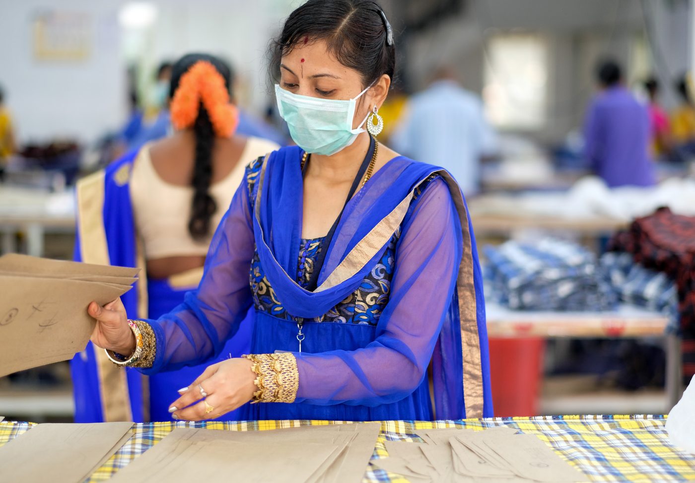 Quality checker inspecting fabric panels at the Indus Intex factory in Bengaluru
